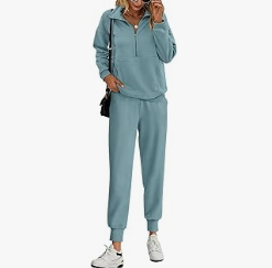 A woman smiling in a soft blue PRETTYGARDEN half-zip sweatsuit and matching pants, the perfect cozy outfit for fall.