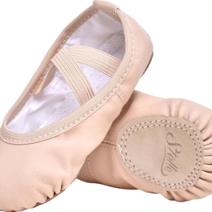 A young girl in a pink Stelle ballet shoe practicing a dance pose on a studio floor.